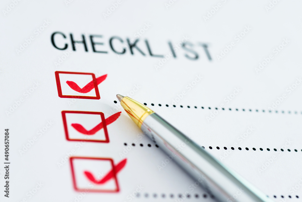 Checklist box on paper with checkmark and pen Checklist box on paper with checkmark and pen