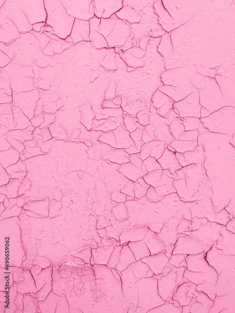 Cracked pink paint on the wall as an abstract background.