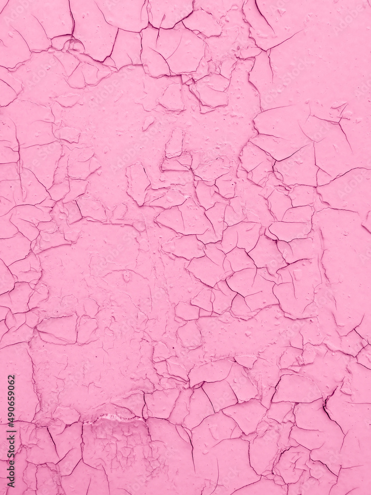 Cracked pink paint on the wall as an abstract background. Cracked pink paint on the wall as an abstract background.