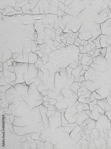 Cracked white paint on the wall as an abstract background.