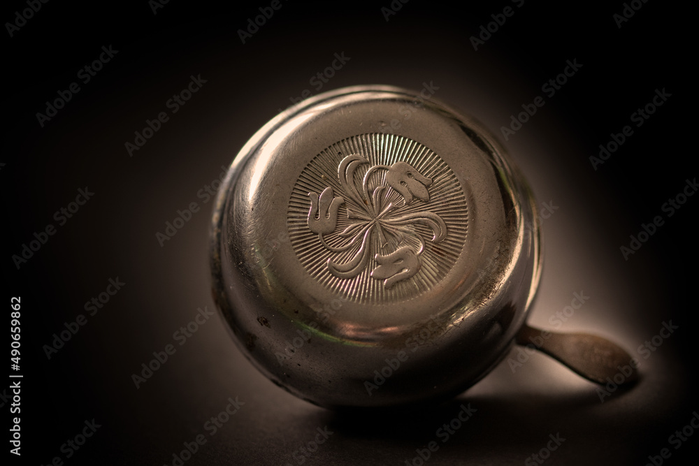 Close up of retro patterned metal bicycle bell isolated on black background Close up of retro patterned metal bicycle bell isolated on black background