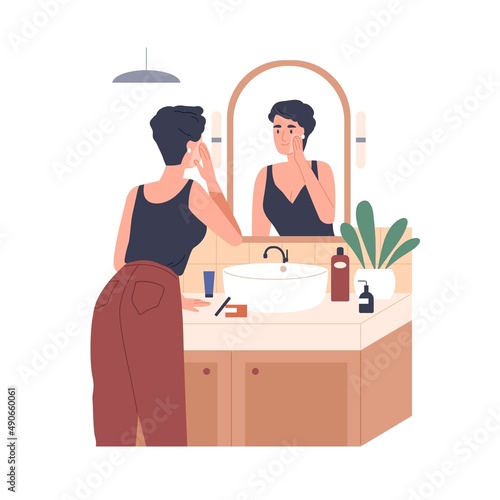 Woman applying moisturizing cream in front of mirror in bathroom. Skincare, beauty routine. Female caring about face skin with cosmetic product. Flat vector illustration isolated on white background