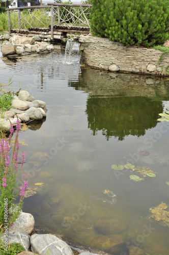Garden pond. Pond in landscape design.