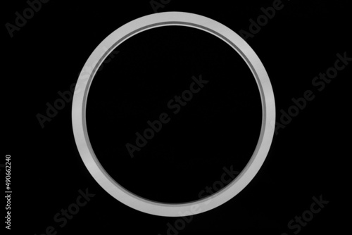 Big black button with white ring on black background