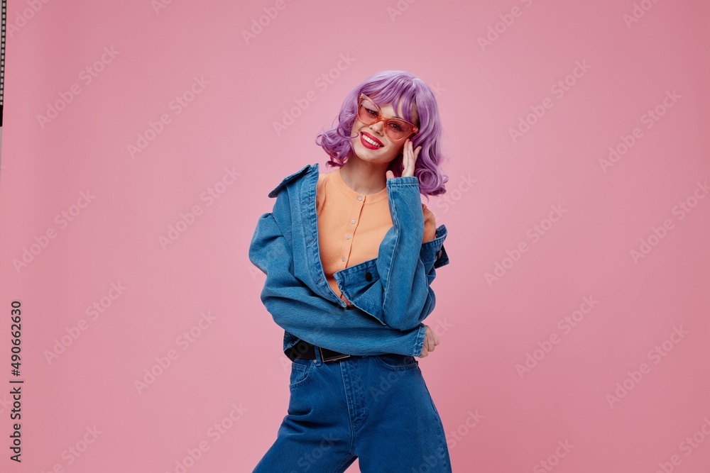 Portrait of a charming lady purple hair fashion glasses denim clothing pink background unaltered Portrait of a charming lady purple hair fashion glasses denim clothing pink background unaltered