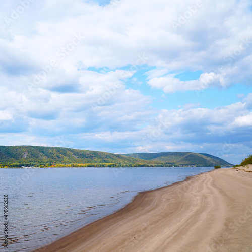 Wallpaper Mural The sandy shore of the big Volga river against the background of a cloudy sky. On the opposite bank of the Zhiguli Mountains Torontodigital.ca