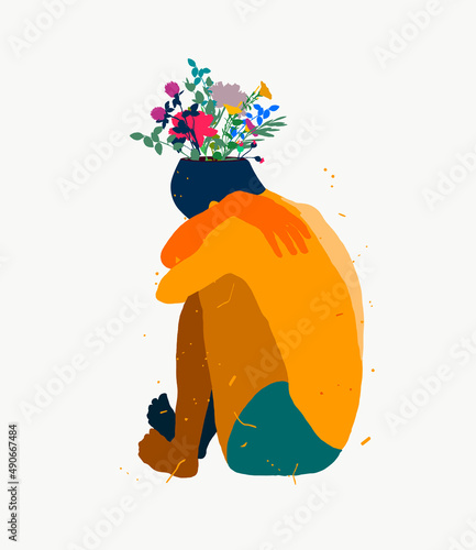 Sad young man sitting on the floor with blossom flowers in the head