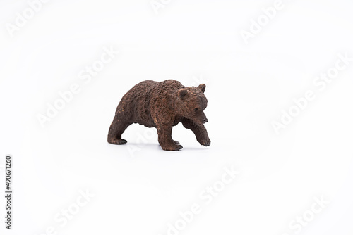 Toy animal figure brown bear on white. 