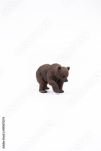 Toy animal figure brown bear on white. © zhennyzhenny