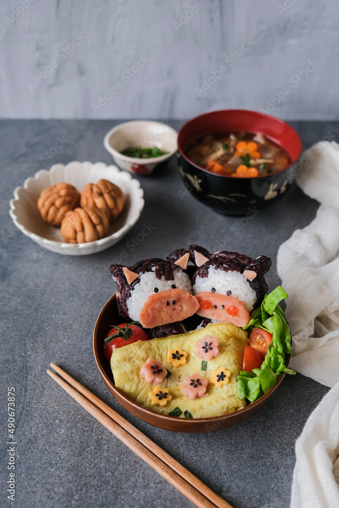Homemade Japanese meal. Animated Shape Ox Onigiri Bento in Black and White Rice. Fun to make and healthy to eat Homemade Japanese meal. Animated Shape Ox Onigiri Bento in Black and White Rice. Fun to make and healthy to eat