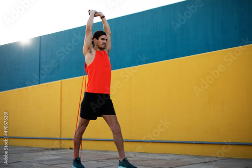 Young muscle man training outside. Fit handsome man doing exercise