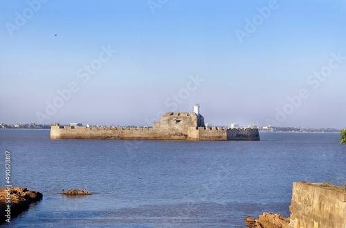 Pani Kotha prison in the distance. Shows the blue water, waves, ocean Walls of diu fort with view of Old Diu City, Portuguese, located in Diu district of Union Territory Daman and Diu India
