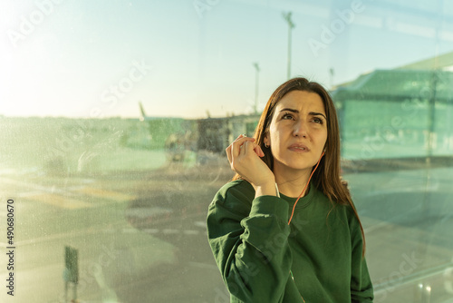 Obraz na płótnie Woman at the airport listening to the flight loudspeaker. w salonie