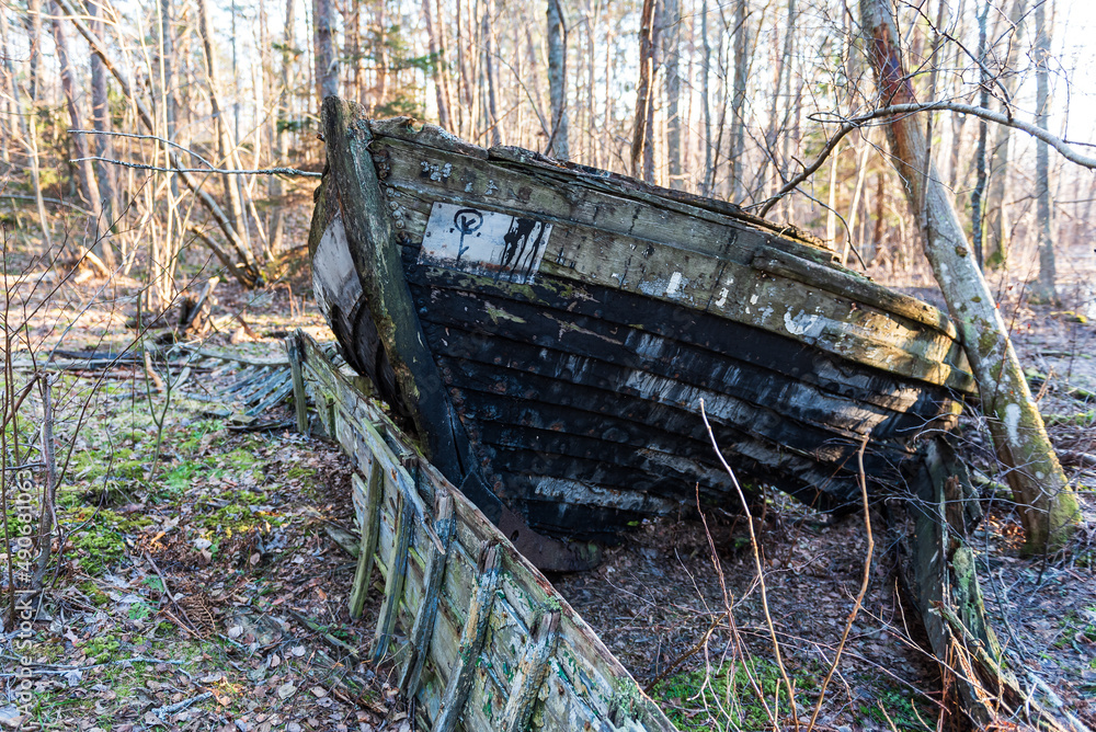 Old abandoned wooden fishing boat in the forest. Boat cemetery. Old abandoned wooden fishing boat in the forest. Boat cemetery.