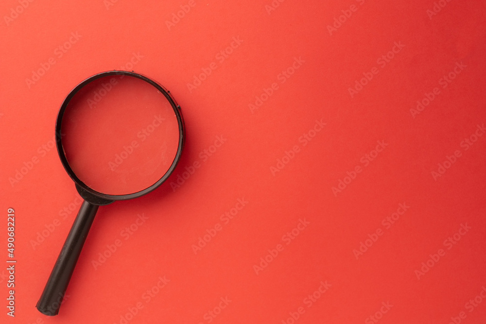 Focus,Searching,research,learing,minimal creative concept.,magnifying glass on bottom left corner over red pastel background with copyspace for put text or logo.,Flat lay or Top view photo. Focus,Searching,research,learing,minimal creative concept.,magnifying glass on bottom left corner over red pastel background with copyspace for put text or logo.,Flat lay or Top view photo.