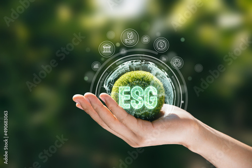 Hand of human holding green earth ESG icon for Environment Society and Governance