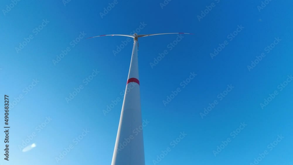 a wind turbine timelapse turning in front of a sunny sky a wind turbine timelapse turning in front of a sunny sky