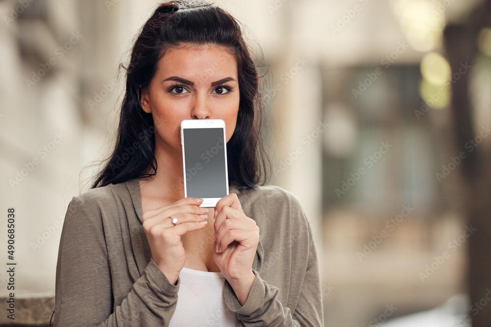 Fototapeta premium Young cute female using smartphone on the street.