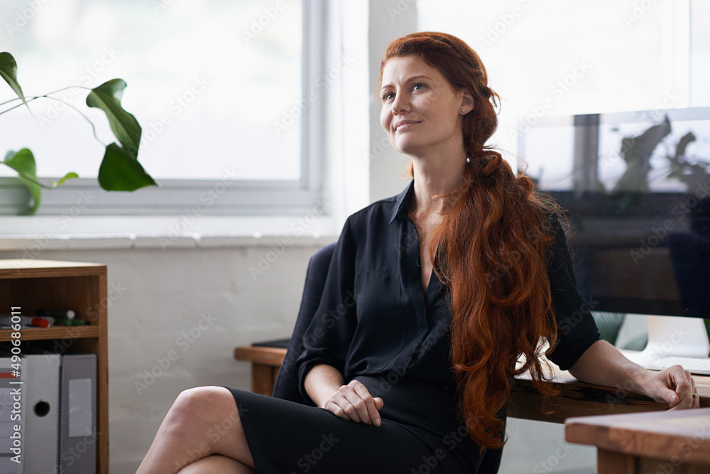 Dont quit your daydream. Shot of a beautiful young businesswoman sitting at her desk. Dont quit your daydream. Shot of a beautiful young businesswoman sitting at her desk.
