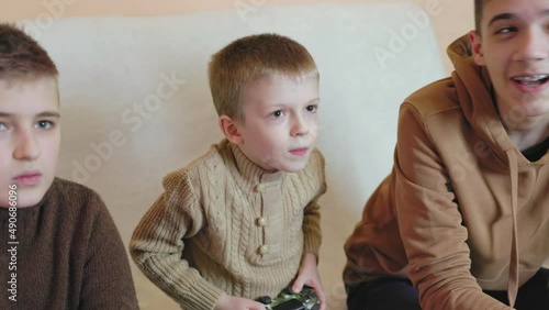 children playing on the console with joysticks in ruhs close-up photo