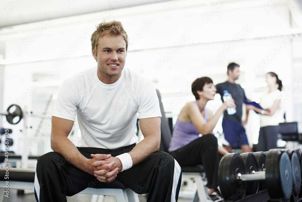 What next.... Cropped shot of a handsome young man sitting in the gym. What next.... Cropped shot of a handsome young man sitting in the gym.
