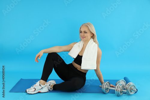 Concept of healthy lifestyle with sporty woman on blue background