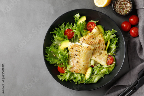 Canvas Print Dish with salad with white sea fish, avocado and cherry tomatoes