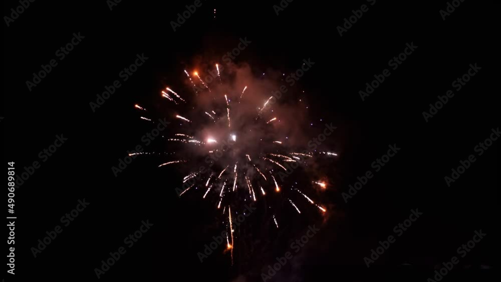 Small new year eve fireworks - glowing explosions on dark sky Small new year eve fireworks - glowing explosions on dark sky