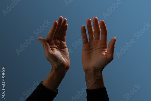 Praying hands with faith in religion and belief in God on dark background. Power of hope or love and devotion. Namaste or Namaskar hands gesture. Prayer position