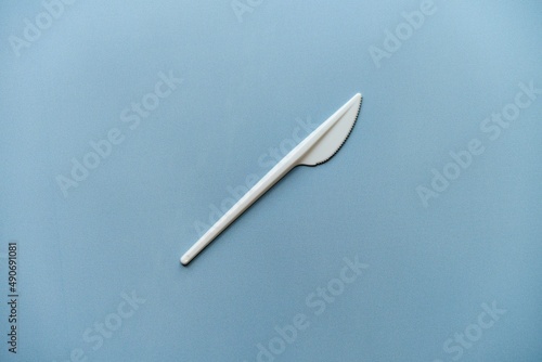 biały plastikowy nóż na niebieskim tle 
