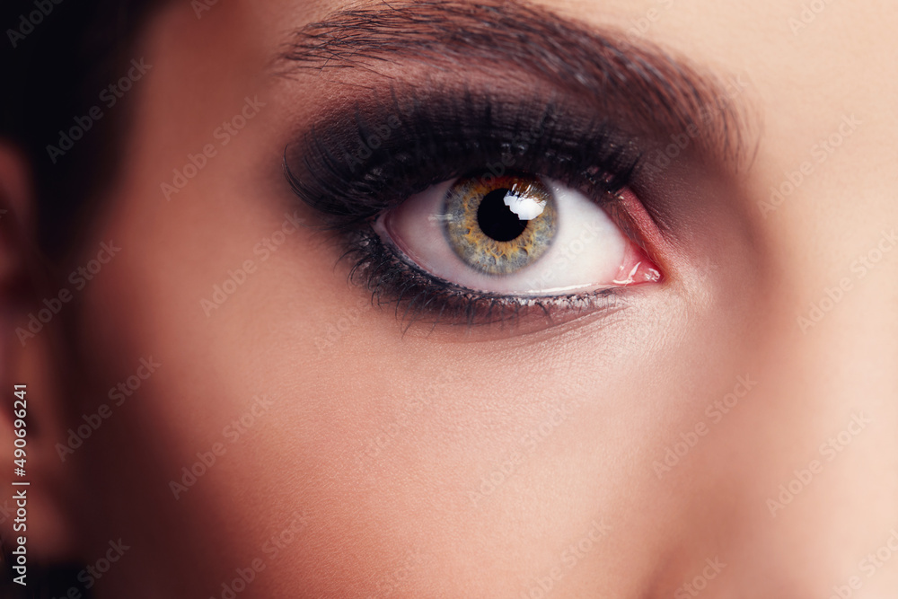 Fototapeta premium Bright eyes. Closeup portrait of a beautiful young woman in the studio.