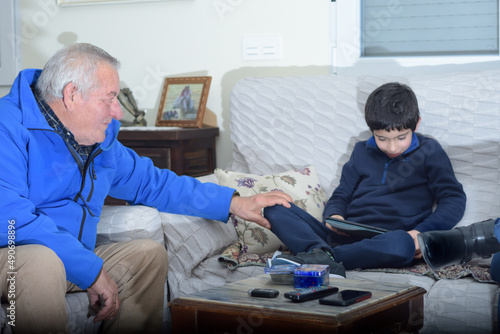 photograph of a grandfather sitting with his grandson. selective focus