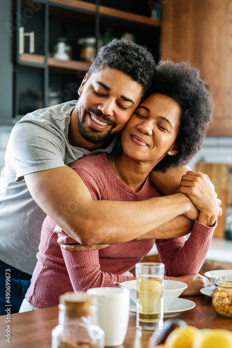 Portrait of happy smiling black couple in love having fun and hugging together