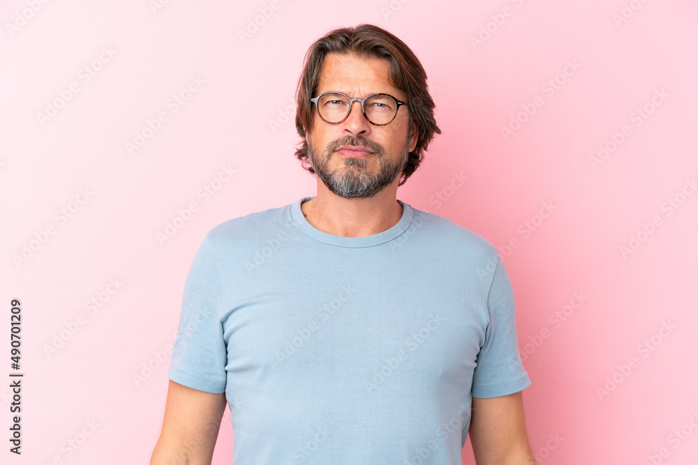 Senior dutch man isolated on pink background With glasses Senior dutch man isolated on pink background With glasses