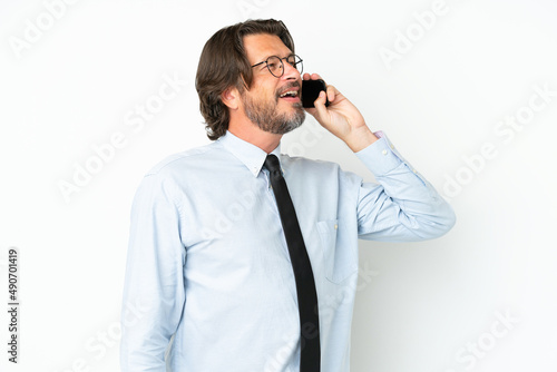 Senior dutch business man isolated on white background keeping a conversation with the mobile phone