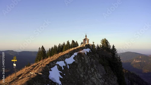 Small wooden chapel on a ridge in the alps at golden hour. Freudenreichkapelle, Bavaria, Germany photo