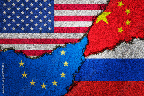 Russia ,Ukraine,usa, and europe Nato painted flags on a wall with a crack , war background concept
