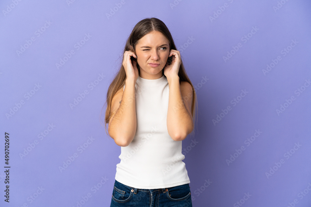 Young Lithuanian woman isolated on purple background frustrated and covering ears Young Lithuanian woman isolated on purple background frustrated and covering ears