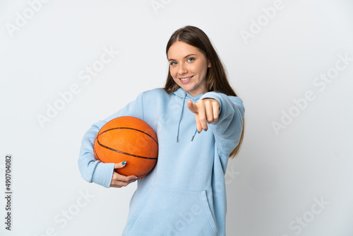 Young Lithuanian woman playing basketball isolated on white background pointing front with happy expression © luismolinero