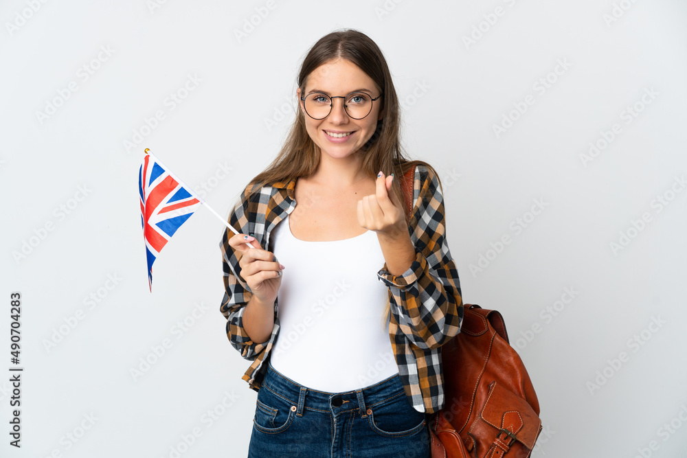 Young Lithuanian woman holding an United Kingdom flag isolated on white background making money gesture Young Lithuanian woman holding an United Kingdom flag isolated on white background making money gesture