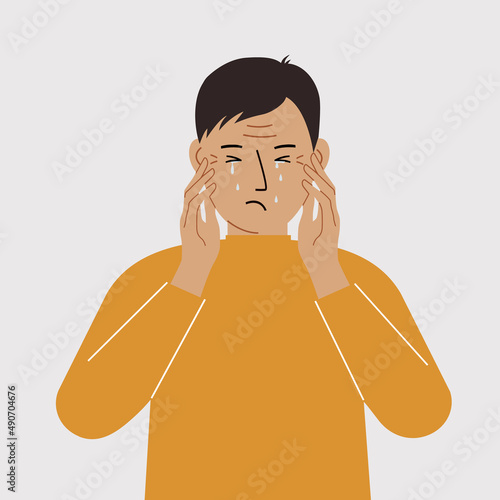 Upset man cries and holds his head with his hands. The concept of resentment, pain and depression.