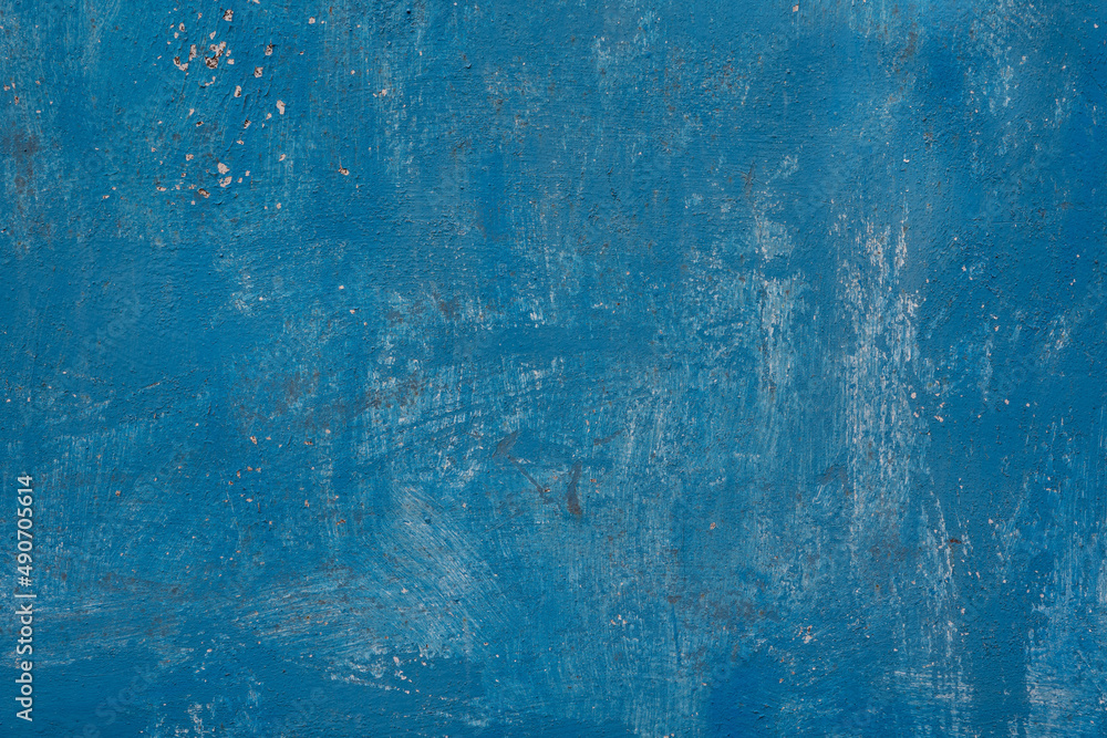 Obraz premium The dry golden curves are on a background of blue shabby wall moaning some shadows and beautiful ornaments