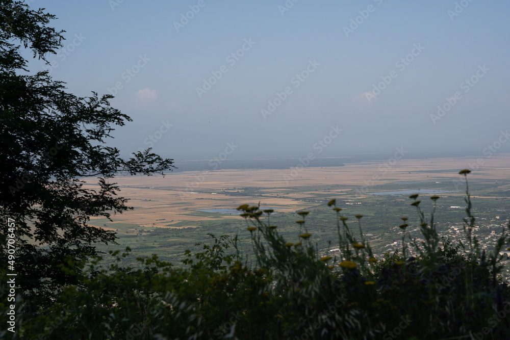 view of the city from the hill in the evening when the sea is quite dark there can be seen the roofs of buildings view of the city from the hill in the evening when the sea is quite dark there can be seen the roofs of buildings