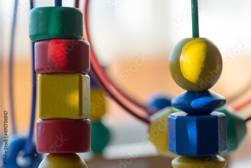 a pyramid of colored cubes and spheres -circle Bead Maze -  is a light background on the theme of baby development