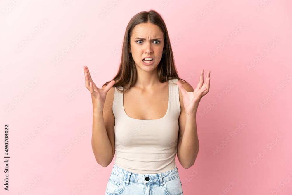Young woman over isolated pink background stressed overwhelmed Young woman over isolated pink background stressed overwhelmed
