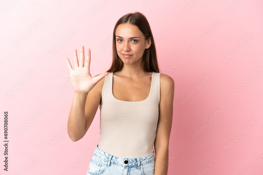Young woman over isolated pink background counting five with fingers Young woman over isolated pink background counting five with fingers