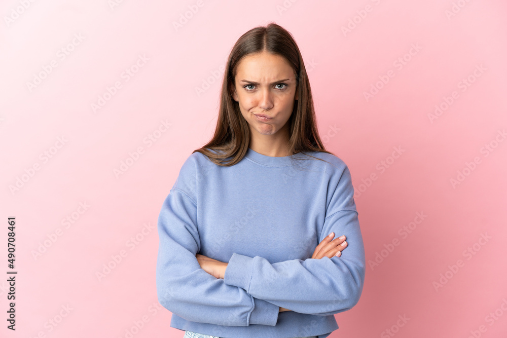 Young woman over isolated pink background feeling upset Young woman over isolated pink background feeling upset