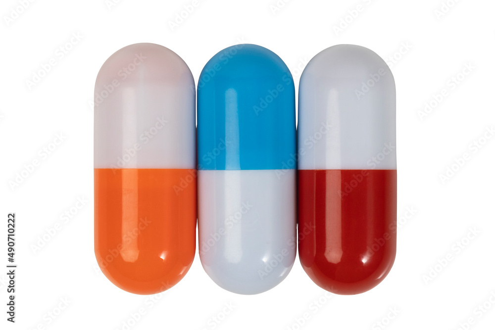 Pills. Three multi-colored capsules isolated on a white background close-up. Medico-pharmaceutical concept. Pills. Three multi-colored capsules isolated on a white background close-up. Medico-pharmaceutical concept.