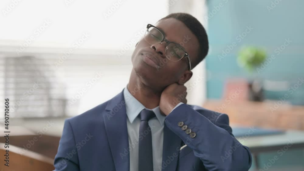 Young African Businessman having Neck Pain Young African Businessman having Neck Pain
