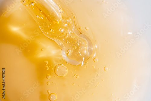 Vitamin C serum liquid texture with dropper, macro shot. photo